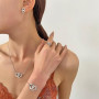 JYIXXZX Parure Bijoux Femme Cœurs Entrelacés Collier Boucles d'oreilles Bracelet Bague Réglable Coeur Pendentif Chaîne avec Zirc